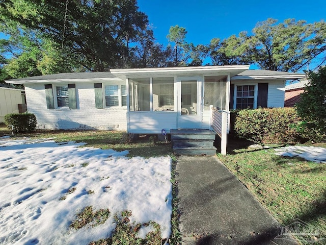 view of front of property featuring a sunroom