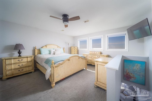 bedroom with carpet floors, visible vents, and a ceiling fan