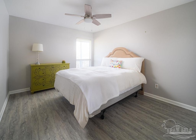 bedroom with ceiling fan, baseboards, and wood finished floors