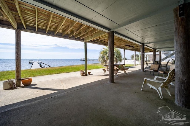 view of patio with a water view, a boat dock, and boat lift