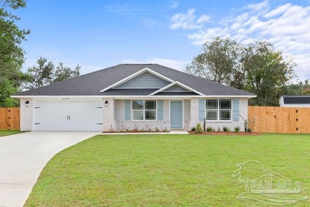 view of front of property featuring a garage and a front lawn