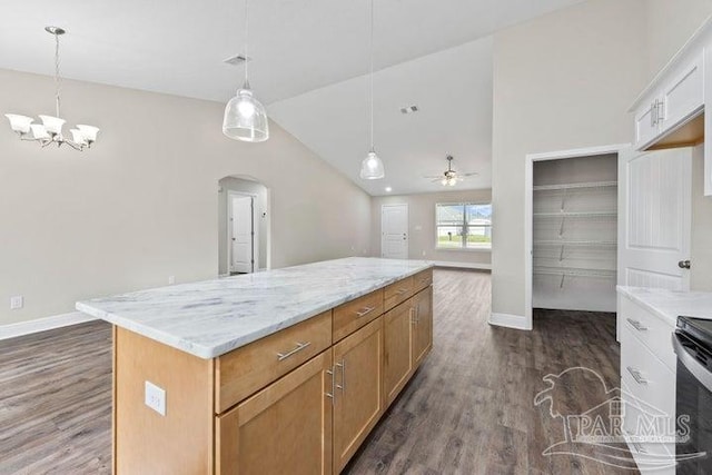 kitchen with white cabinets, a kitchen island, decorative light fixtures, and ceiling fan with notable chandelier