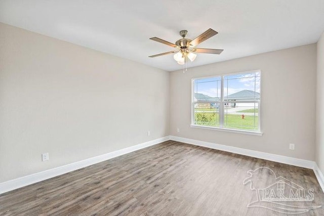 unfurnished room featuring dark hardwood / wood-style floors and ceiling fan