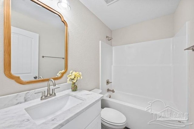 full bathroom featuring shower / bathing tub combination, vanity, and toilet