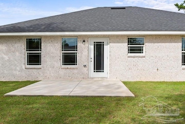 back of house featuring a lawn and a patio