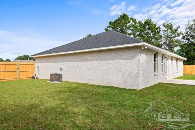 view of property exterior featuring a yard and central AC