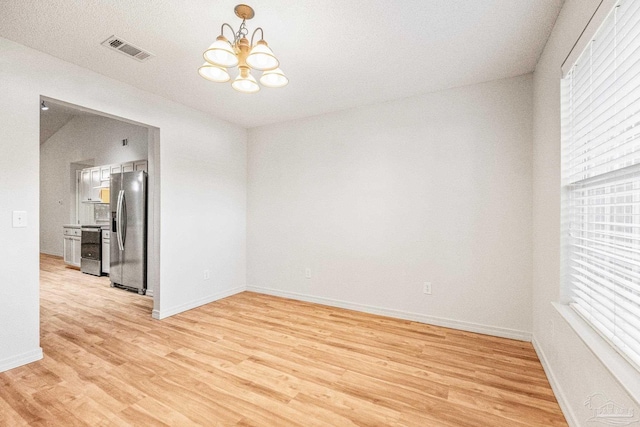 6240 Tributary St, Pensacola, FL 32526 - unfurnished room with an inviting chandelier and light hardwood / wood-style floors
