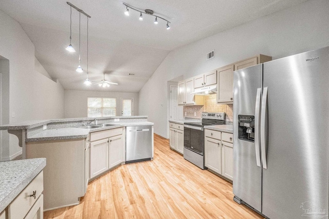 6240 Tributary St, Pensacola, FL 32526 - kitchen featuring sink, vaulted ceiling, light hardwood / wood-style flooring, appliances with stainless steel finishes, and pendant lighting