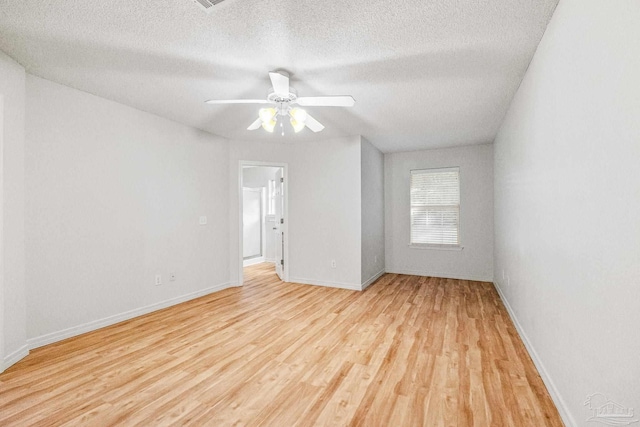 6240 Tributary St, Pensacola, FL 32526 - empty room featuring ceiling fan, light hardwood / wood-style flooring, and a textured ceiling