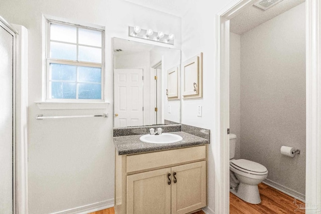6240 Tributary St, Pensacola, FL 32526 - bathroom featuring vanity, hardwood / wood-style floors, and toilet