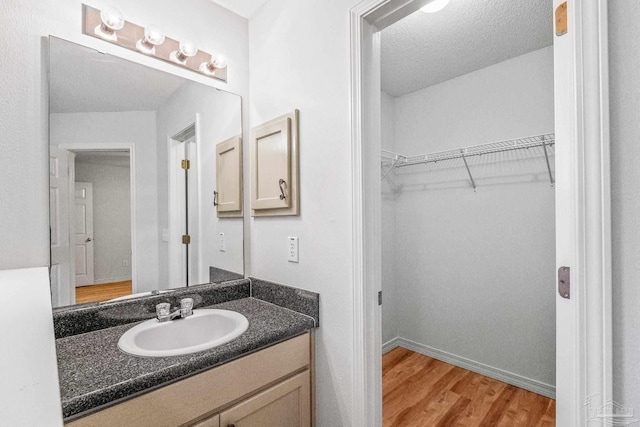 6240 Tributary St, Pensacola, FL 32526 - bathroom with vanity, hardwood / wood-style floors, and a textured ceiling