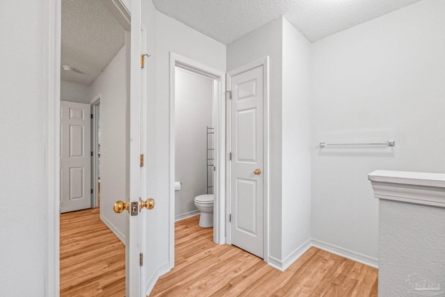 6240 Tributary St, Pensacola, FL 32526 - bathroom with a textured ceiling, wood-type flooring, and toilet
