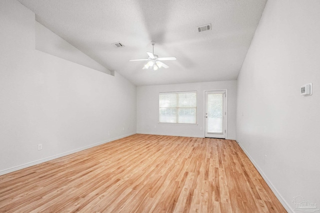 6240 Tributary St, Pensacola, FL 32526 - empty room featuring ceiling fan, lofted ceiling, a textured ceiling, and light wood-type flooring
