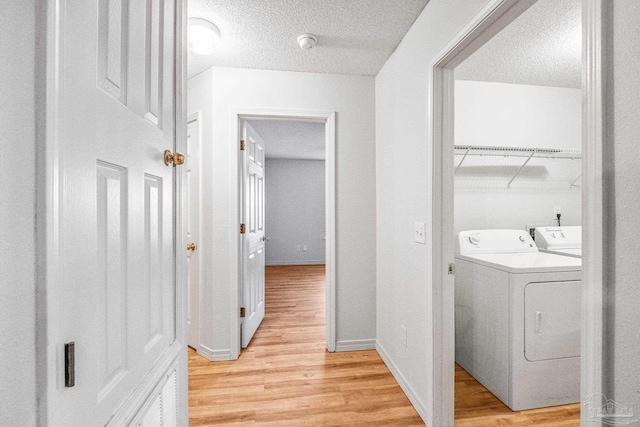 6240 Tributary St, Pensacola, FL 32526 - clothes washing area with separate washer and dryer, light hardwood / wood-style flooring, and a textured ceiling