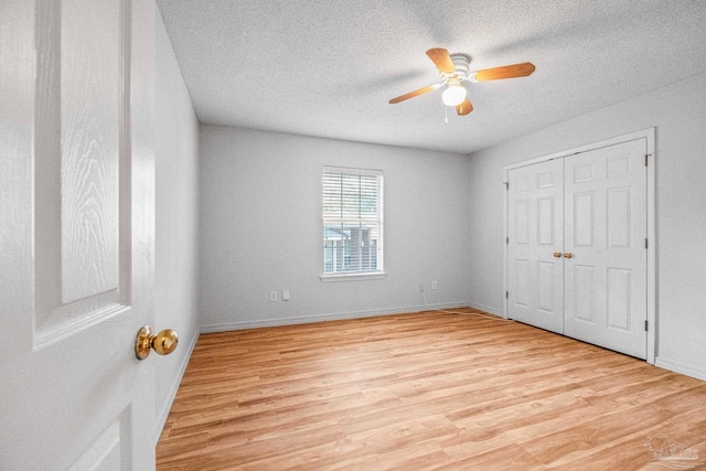 6240 Tributary St, Pensacola, FL 32526 - unfurnished bedroom featuring ceiling fan, light hardwood / wood-style flooring, a closet, and a textured ceiling