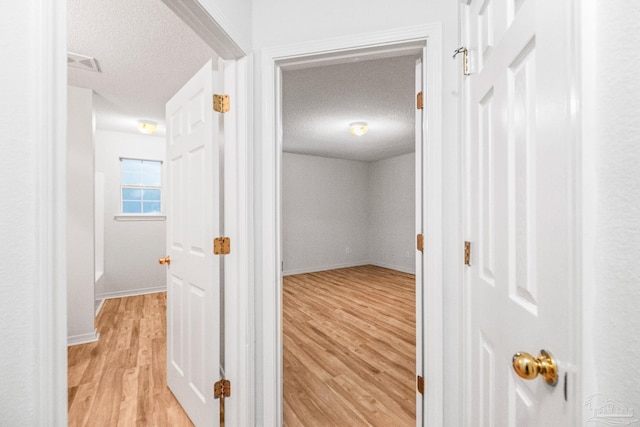 6240 Tributary St, Pensacola, FL 32526 - hall featuring light hardwood / wood-style flooring and a textured ceiling