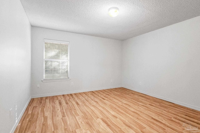 6240 Tributary St, Pensacola, FL 32526 - empty room featuring a textured ceiling and light hardwood / wood-style floors