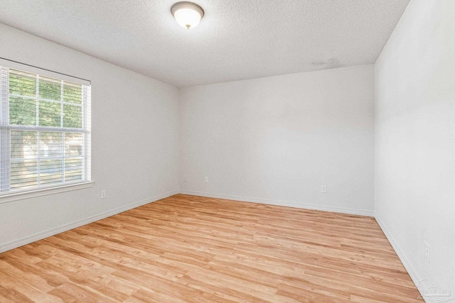 6240 Tributary St, Pensacola, FL 32526 - spare room featuring light hardwood / wood-style flooring and a textured ceiling