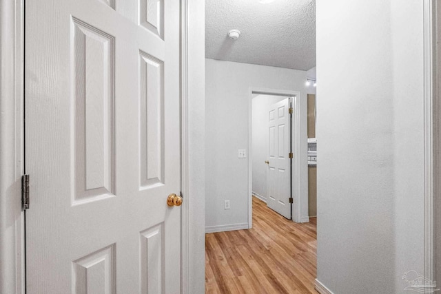 6240 Tributary St, Pensacola, FL 32526 - hall featuring a textured ceiling and light wood-type flooring