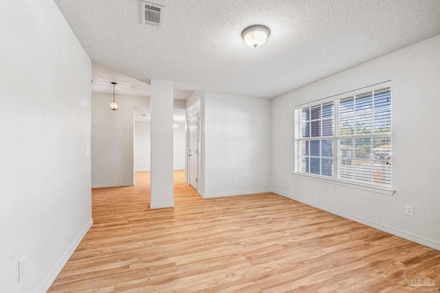6240 Tributary St, Pensacola, FL 32526 - empty room featuring a textured ceiling and light hardwood / wood-style flooring
