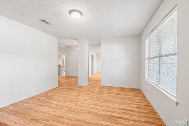 6240 Tributary St, Pensacola, FL 32526 - empty room featuring a textured ceiling and light wood-type flooring