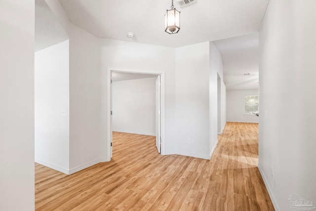 6240 Tributary St, Pensacola, FL 32526 - corridor featuring a textured ceiling and light hardwood / wood-style floors