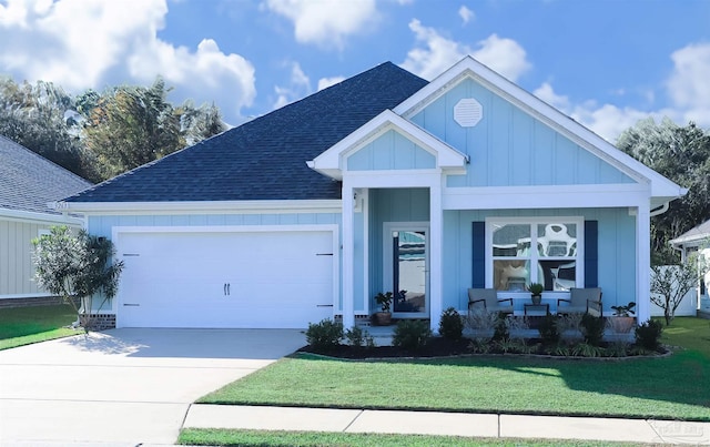 view of front of home featuring a front lawn and a garage