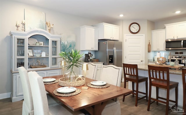 dining space featuring dark wood-type flooring