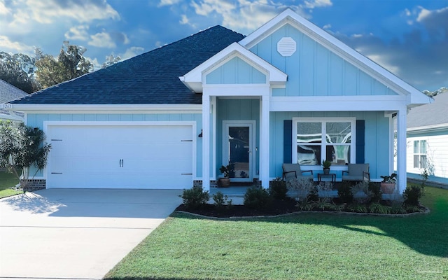 view of front of property with a garage and a front lawn