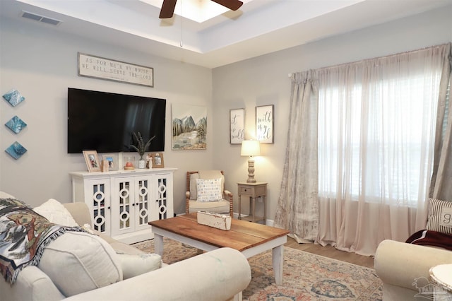 living room featuring ceiling fan and hardwood / wood-style floors