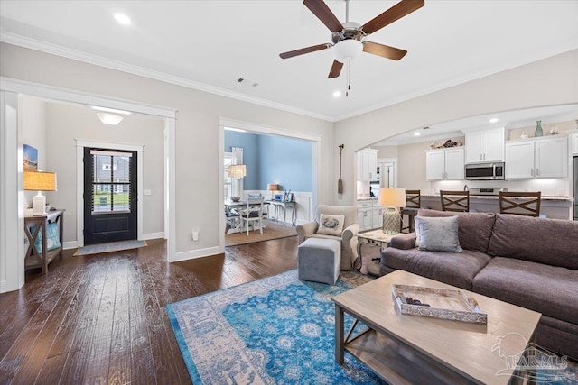 1504 Cadence Loop, Cantonment, FL 32533 - living area with arched walkways, dark wood-style floors, ceiling fan, baseboards, and recessed lighting