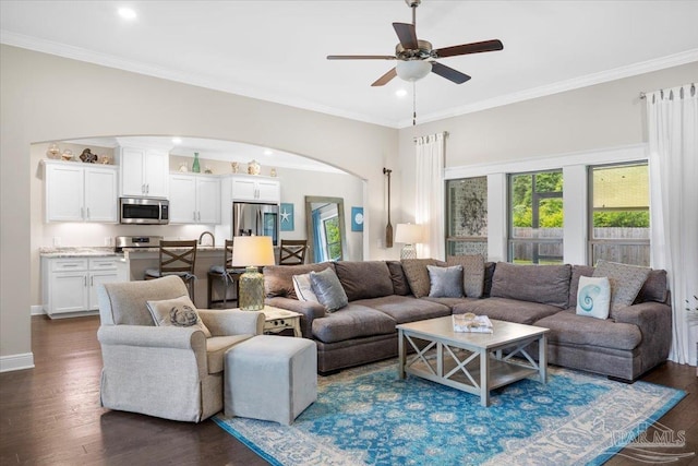 1504 Cadence Loop, Cantonment, FL 32533 - living room featuring arched walkways, ceiling fan, dark wood-type flooring, recessed lighting, and crown molding