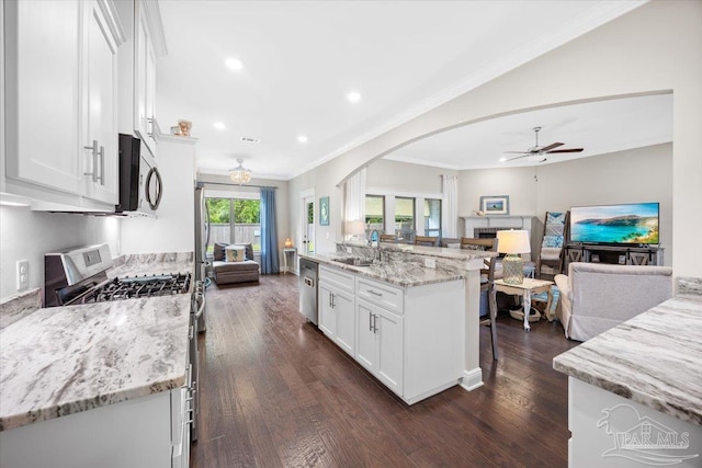 1504 Cadence Loop, Cantonment, FL 32533 - kitchen with appliances with stainless steel finishes, ceiling fan, open floor plan, a sink, and white cabinets