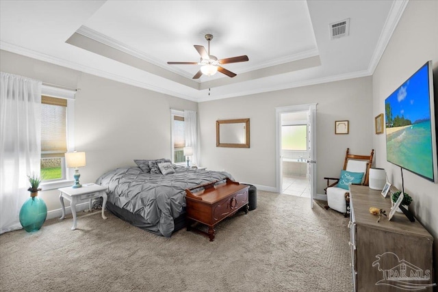 1504 Cadence Loop, Cantonment, FL 32533 - carpeted bedroom featuring crown molding, a raised ceiling, ensuite bathroom, baseboards, and a ceiling fan