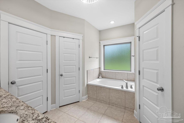1504 Cadence Loop, Cantonment, FL 32533 - bathroom featuring tile patterned flooring, a bath, a sink, and baseboards