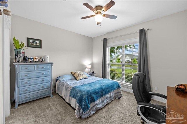 1504 Cadence Loop, Cantonment, FL 32533 - bedroom with light colored carpet, a desk, and a ceiling fan