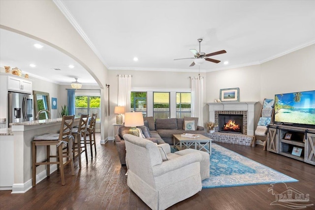 1504 Cadence Loop, Cantonment, FL 32533 - living area featuring a ceiling fan, arched walkways, recessed lighting, a fireplace, and dark wood-style floors