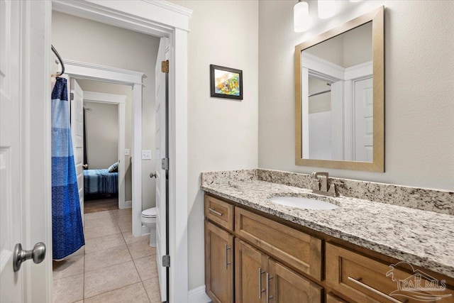 1504 Cadence Loop, Cantonment, FL 32533 - ensuite bathroom featuring vanity, toilet, tile patterned floors, and baseboards