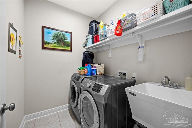 1504 Cadence Loop, Cantonment, FL 32533 - laundry area featuring washer and dryer, baseboards, and light tile patterned floors