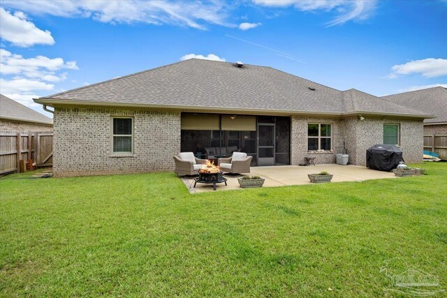 1504 Cadence Loop, Cantonment, FL 32533 - rear view of house featuring brick siding, an outdoor fire pit, a patio area, and a shingled roof