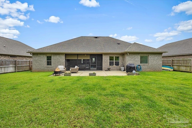 1504 Cadence Loop, Cantonment, FL 32533 - rear view of property featuring brick siding, a patio, a sunroom, and a shingled roof