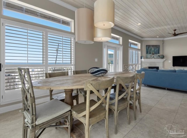 dining area with light tile patterned floors, ornamental molding, and wooden ceiling