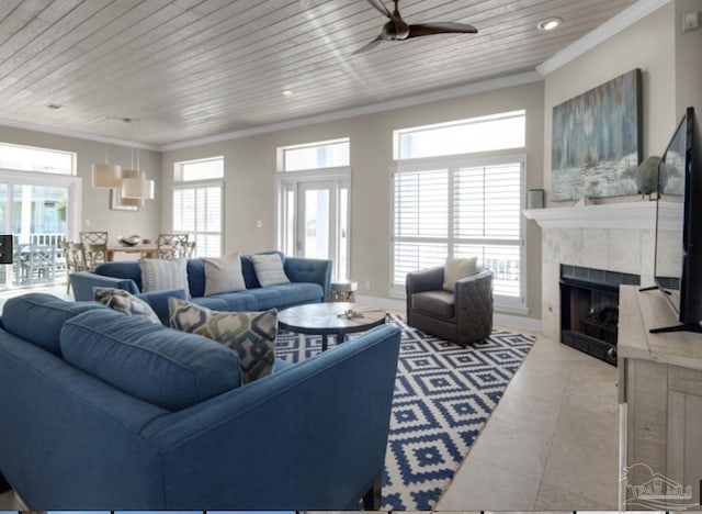 tiled living room with a tiled fireplace, crown molding, a healthy amount of sunlight, and wooden ceiling