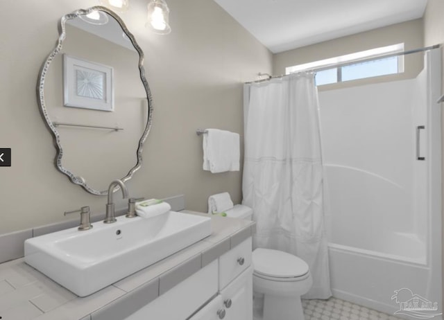 full bathroom featuring vanity, shower / tub combo with curtain, and toilet