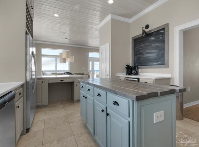 kitchen featuring stainless steel appliances, crown molding, a center island, and light tile patterned floors