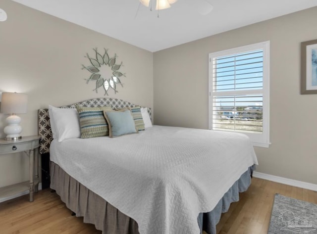 bedroom featuring light hardwood / wood-style floors and ceiling fan