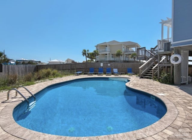 view of swimming pool featuring a patio area