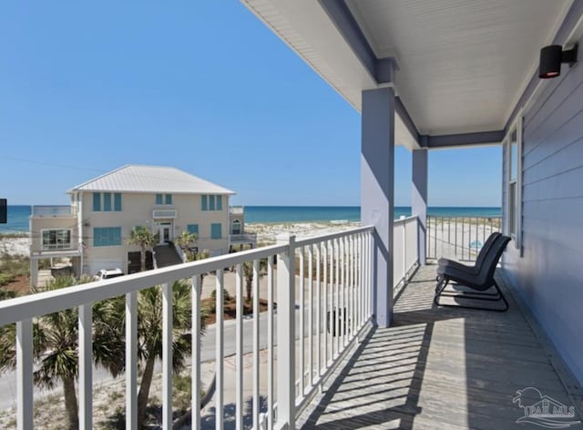 balcony with a water view and a beach view