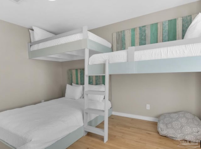 bedroom with wood-type flooring