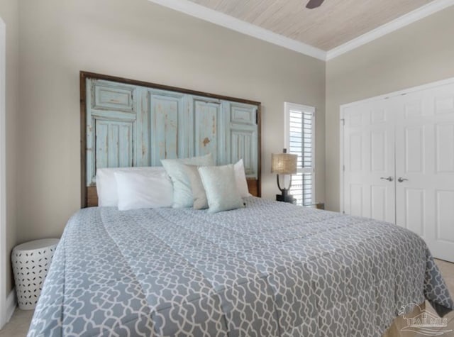 bedroom featuring ornamental molding, wooden ceiling, ceiling fan, and a closet